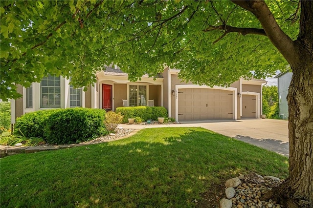 21502 W 98th Ter, Lenexa, KS 66220 - obstructed view of property with a garage, driveway, a front lawn, and stucco siding