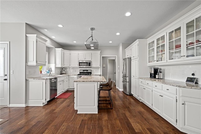 21502 W 98th Ter, Lenexa, KS 66220 - kitchen with stainless steel appliances, white cabinets, backsplash, glass insert cabinets, and dark wood-style flooring