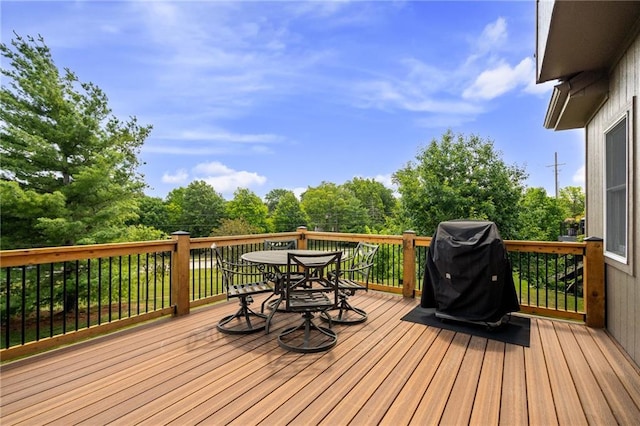 21502 W 98th Ter, Lenexa, KS 66220 - deck featuring outdoor dining area, a grill, and view of wooded area