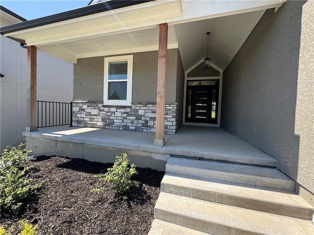 22415 87th Ter, Lenexa, KS 66227 - doorway to property featuring a porch, stucco siding, and stone siding