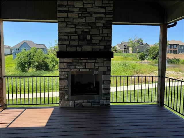 22415 87th Ter, Lenexa, KS 66227 - wooden terrace with an outdoor stone fireplace and a residential view