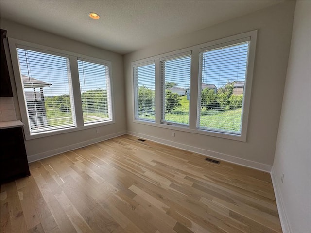22415 87th Ter, Lenexa, KS 66227 - unfurnished dining area featuring light wood finished floors and a textured ceiling