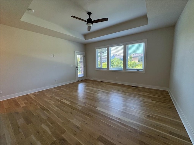 22415 87th Ter, Lenexa, KS 66227 - spare room with a tray ceiling, wood finished floors, ceiling fan, and a smoke detector