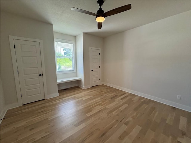 22415 87th Ter, Lenexa, KS 66227 - unfurnished bedroom with light wood finished floors and ceiling fan