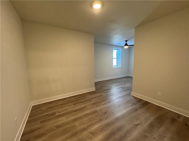 22415 87th Ter, Lenexa, KS 66227 - empty room featuring baseboards and dark wood-type flooring