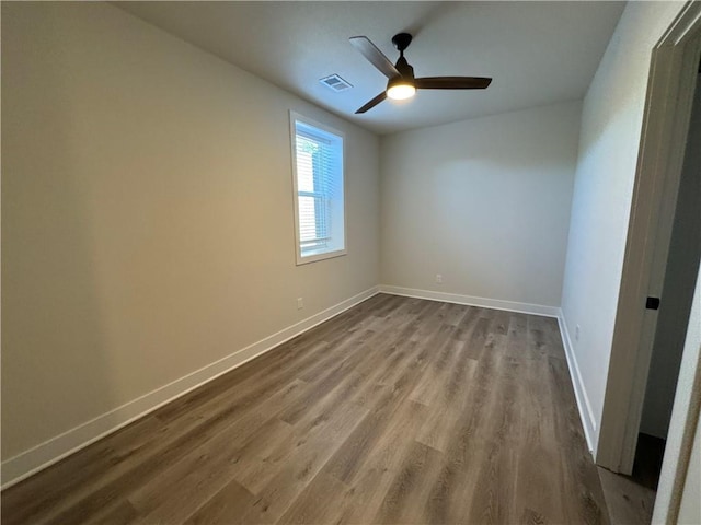 22415 87th Ter, Lenexa, KS 66227 - empty room with dark wood finished floors and a ceiling fan