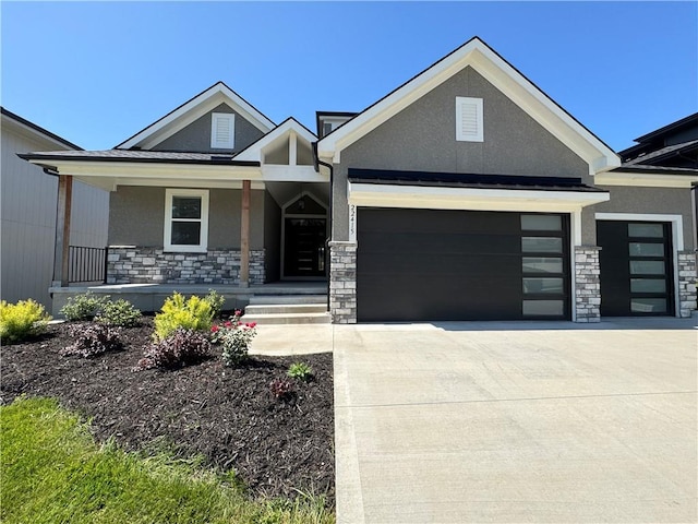 22415 87th Ter, Lenexa, KS 66227 - craftsman-style home featuring stone siding, stucco siding, a garage, driveway, and a porch