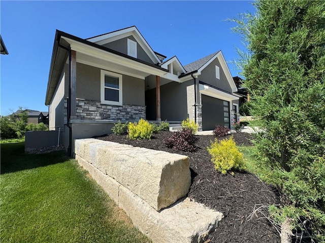 22415 87th Ter, Lenexa, KS 66227 - view of front of property featuring stucco siding, a garage, stone siding, and a front lawn