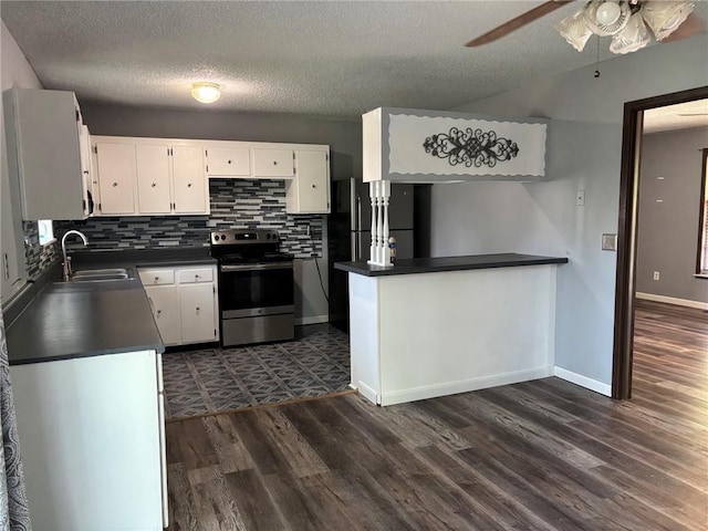 18105 E 18th Ter N, Independence, MO 64058 - kitchen featuring stainless steel range with electric cooktop, dark countertops, ceiling fan, white cabinets, and a textured ceiling