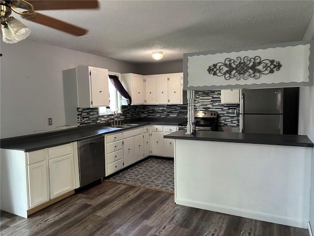 18105 E 18th Ter N, Independence, MO 64058 - kitchen with stainless steel appliances, dark countertops, white cabinetry, dark wood-style flooring, and backsplash