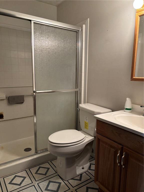 18105 E 18th Ter N, Independence, MO 64058 - full bath featuring vanity, a stall shower, and tile patterned floors