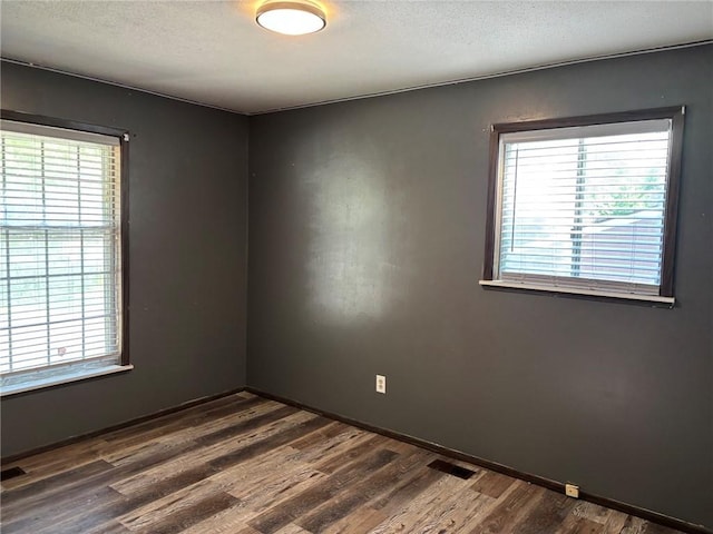 18105 E 18th Ter N, Independence, MO 64058 - spare room with healthy amount of natural light, dark wood-style floors, and a textured ceiling
