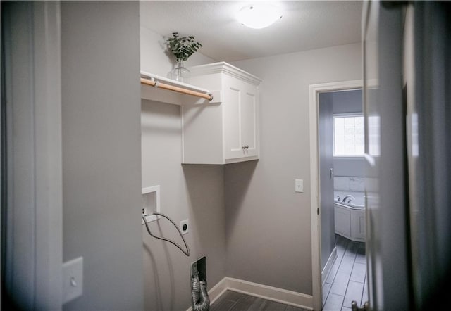 5073 NW Timberline Dr, Riverside, MO 64150 - laundry room featuring cabinet space, hookup for a washing machine, and wood finished floors