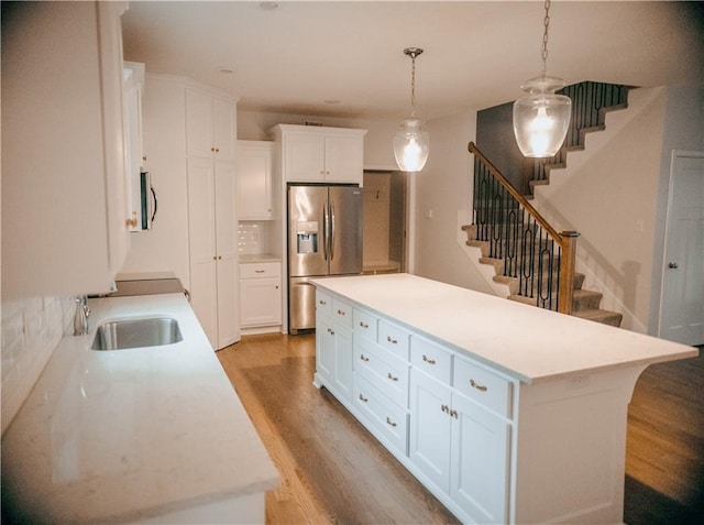 5073 NW Timberline Dr, Riverside, MO 64150 - kitchen with stainless steel appliances, light wood finished floors, light countertops, and white cabinets