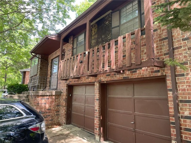 3212 Canterbury Rd, Blue Springs, MO 64015 - view of side of home with brick siding, an attached garage, and concrete driveway