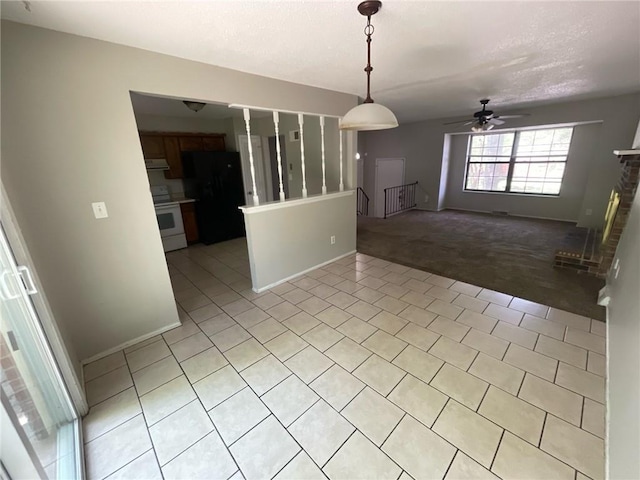 3212 Canterbury Rd, Blue Springs, MO 64015 - empty room with light carpet, ceiling fan, and light tile patterned floors