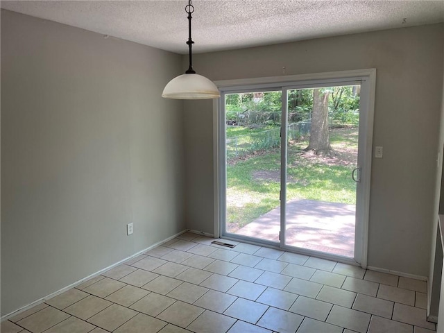 3212 Canterbury Rd, Blue Springs, MO 64015 - unfurnished dining area featuring a textured ceiling and light tile patterned flooring