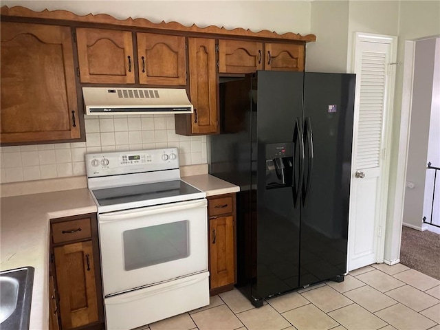 3212 Canterbury Rd, Blue Springs, MO 64015 - kitchen featuring white range with electric stovetop, black fridge with ice dispenser, extractor fan, and light countertops