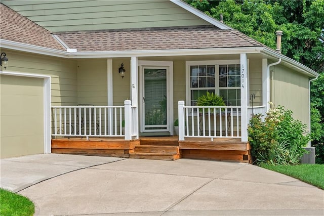 17014 E 45th St S, Independence, MO 64055 - entrance to property with a porch, a shingled roof, a garage, and concrete driveway