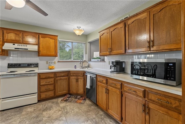 17014 E 45th St S, Independence, MO 64055 - kitchen with stainless steel appliances, under cabinet range hood, brown cabinetry, tasteful backsplash, and a textured ceiling