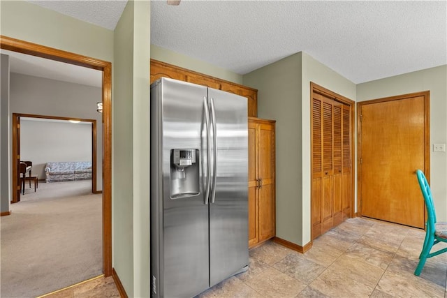 17014 E 45th St S, Independence, MO 64055 - kitchen featuring stainless steel fridge with ice dispenser, a textured ceiling, and brown cabinetry