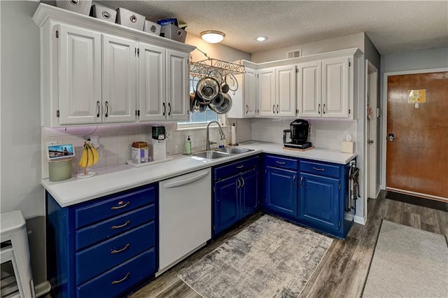 2013 NE Summerfield Ct, Blue Springs, MO 64029 - kitchen with white dishwasher, blue cabinets, white cabinetry, light wood finished floors, and a textured ceiling