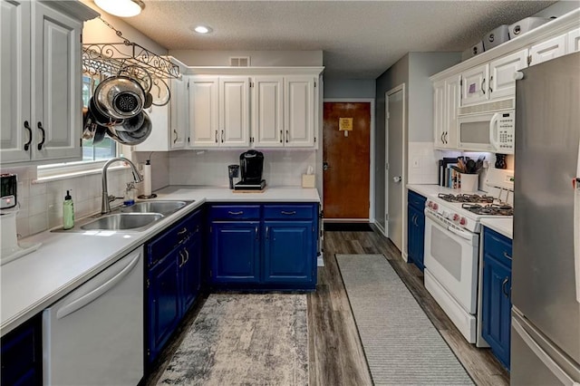 2013 NE Summerfield Ct, Blue Springs, MO 64029 - kitchen featuring white appliances, blue cabinets, light wood-type flooring, white cabinetry, and a textured ceiling