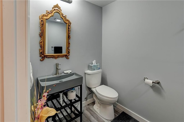 2013 NE Summerfield Ct, Blue Springs, MO 64029 - half bathroom with toilet and wood finished floors