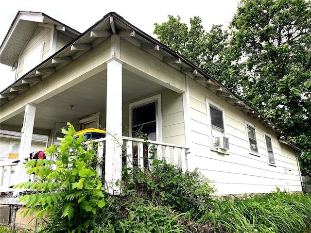 5433 E 29th St, Kansas City, MO 64128 - view of side of property with covered porch and cooling unit