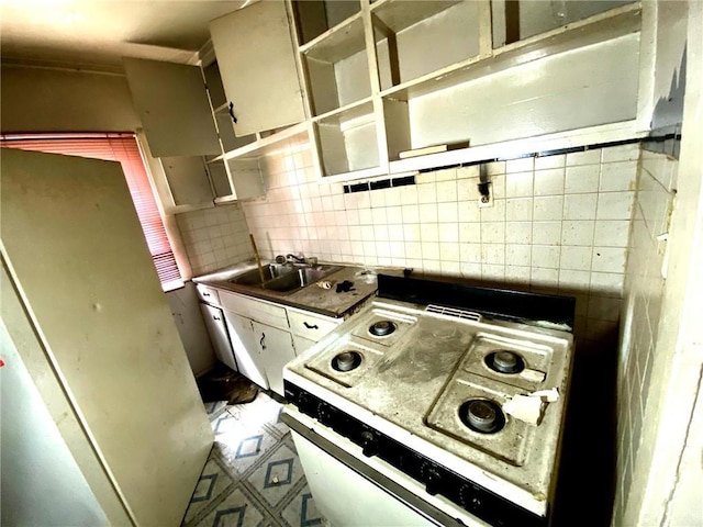 5433 E 29th St, Kansas City, MO 64128 - kitchen featuring backsplash, white electric range oven, and tile patterned floors