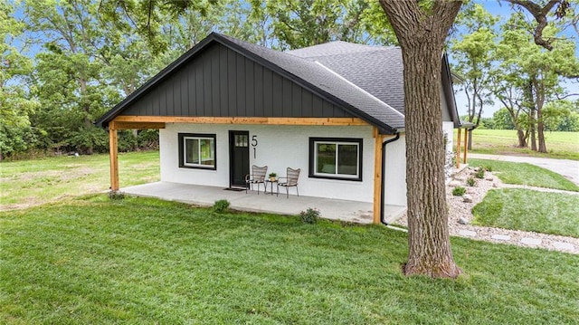 51 SE 208th St, Holt, MO 64048 - view of front of property featuring a front yard, roof with shingles, and board and batten siding