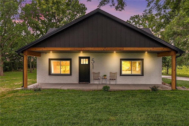 51 SE 208th St, Holt, MO 64048 - view of front of home featuring a front yard, a patio, and brick siding