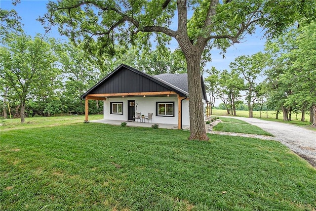 51 SE 208th St, Holt, MO 64048 - modern inspired farmhouse featuring a front yard and stucco siding
