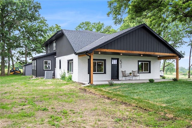 51 SE 208th St, Holt, MO 64048 - rear view of house featuring roof with shingles, brick siding, and a yard