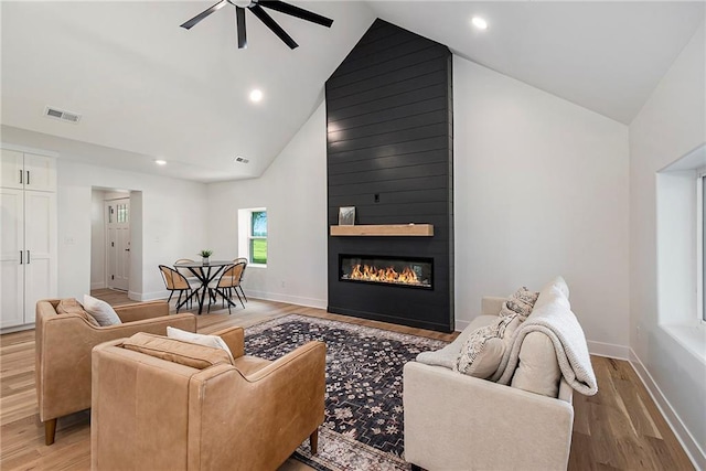51 SE 208th St, Holt, MO 64048 - living area with high vaulted ceiling, light wood-type flooring, a ceiling fan, a fireplace, and recessed lighting