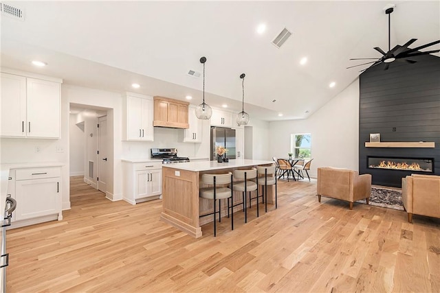 51 SE 208th St, Holt, MO 64048 - kitchen featuring stainless steel appliances, recessed lighting, ceiling fan, light wood finished floors, and a breakfast bar area