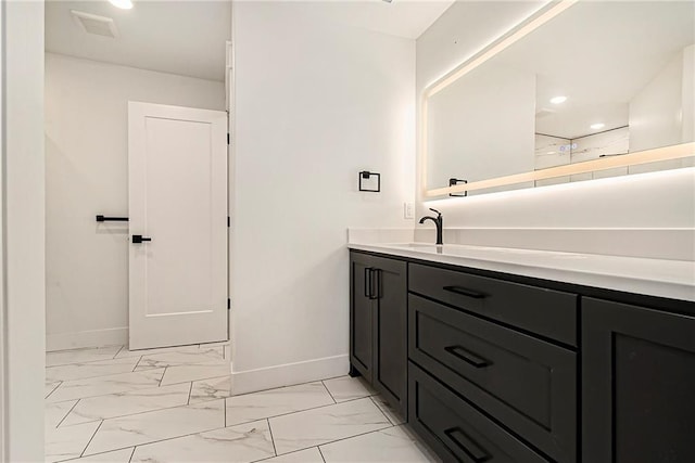 51 SE 208th St, Holt, MO 64048 - bathroom featuring vanity, marble look tiles, and recessed lighting