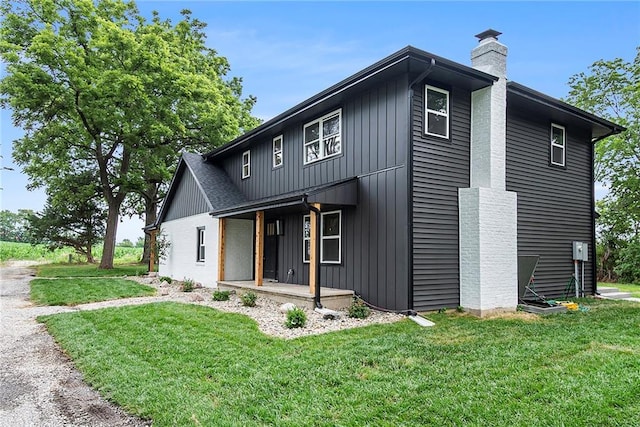 51 SE 208th St, Holt, MO 64048 - view of front of property with a chimney, a front yard, and covered porch
