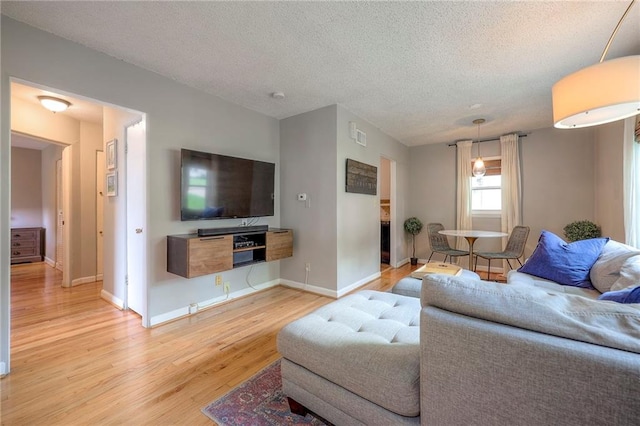 7000 Dearborn St, Overland Park, KS 66204 - living room with a textured ceiling and light wood-style flooring