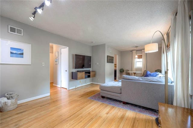 7000 Dearborn St, Overland Park, KS 66204 - living room with light wood-style flooring and a textured ceiling