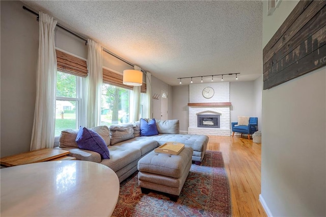 7000 Dearborn St, Overland Park, KS 66204 - living room with a fireplace, a textured ceiling, and wood finished floors