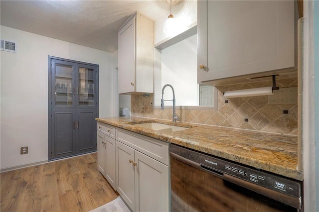 7000 Dearborn St, Overland Park, KS 66204 - kitchen with dishwasher, decorative backsplash, light stone counters, and light wood-style flooring