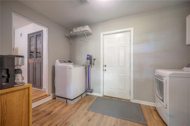 7000 Dearborn St, Overland Park, KS 66204 - laundry area with light wood-style floors and washer and dryer