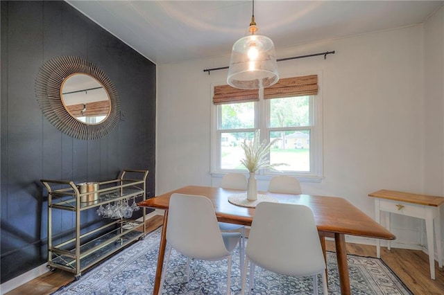 7000 Dearborn St, Overland Park, KS 66204 - dining space featuring wood finished floors, an accent wall, and wood walls