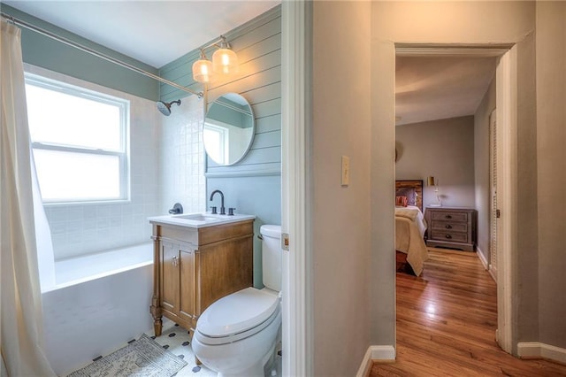 7000 Dearborn St, Overland Park, KS 66204 - full bath with shower / bath combination with curtain, vanity, wood finished floors, and ensuite bathroom