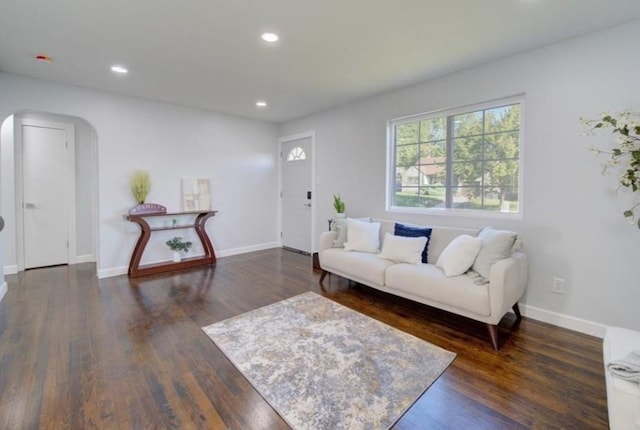 2507 E 69th St, Kansas City, MO 64132 - living area with arched walkways, recessed lighting, and dark wood-type flooring