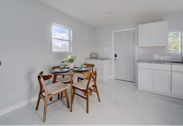 2507 E 69th St, Kansas City, MO 64132 - dining space featuring baseboards and light marble finish floors