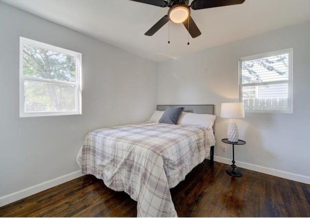 2507 E 69th St, Kansas City, MO 64132 - bedroom with multiple windows, wood finished floors, and ceiling fan