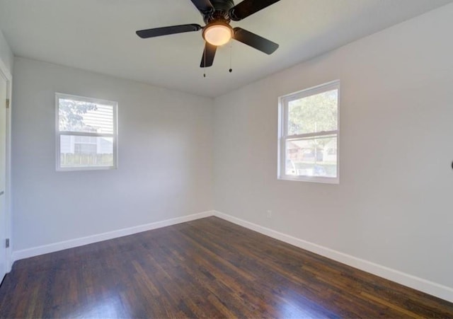 2507 E 69th St, Kansas City, MO 64132 - empty room with dark wood finished floors and a ceiling fan