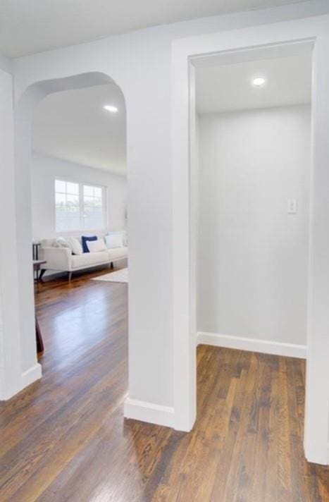 2507 E 69th St, Kansas City, MO 64132 - corridor featuring arched walkways, wood finished floors, and recessed lighting